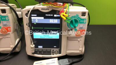 2 x Philips MRx Defibrillators Including ECG and Printer Options with 2 x Philips M3539A Power Adapters and 2 x Philips M3538A Batteries 2 x Paddle Lead, 2 x Philips M3725A Test Loads and 2 x 3 Lead ECG Leads (Both Power Up) *US00546551 - US00546543* - 2