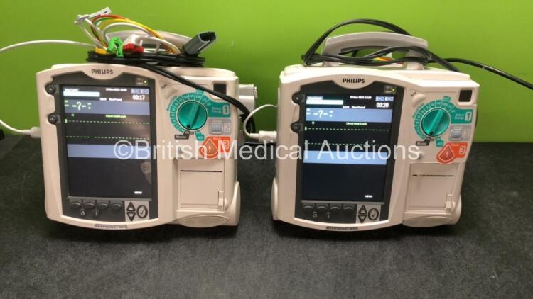 2 x Philips MRx Defibrillators Including ECG and Printer Options with 2 x Philips M3539A Power Adapters 2 x Paddle Lead, and 2 x 3 Lead ECG Leads (Both Power Up, 1 with Damaged Screen-See Photo) *US00546555, US00546538*