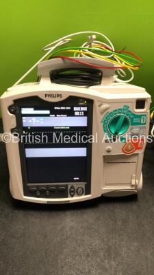 2 x Philips MRx Defibrillators Including ECG and Printer Options with 2 x Philips M3539A Power Adapters 2 x Paddle Lead, and 2 x 3 Lead ECG Leads (Both Power Up) *US00565620, US003151575* - 2