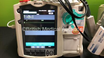 2 x Philips MRx Defibrillators Including Pacer, ECG and Printer Options with 2 x Philips M3539A Power Adapters and 2 x Philips M3538A Batteries 2 x Paddle Lead, 2 x Philips M3725A Test Loads and 2 x 3 Lead ECG Leads (Both Power Up) *US00546523 - US0032222 - 3