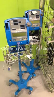 2 x GE Dinamap Pro 400V2 Vital Signs Monitors on Stands, 2 x Alaris Charging Stations (Cage Not Included) and 1 x Marsden Weighing Scales - 2