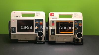 2 x Medtronic Physio-Control Lifepak 12 Biphasic 12 Lead Defibrillators / Monitors with CO2, SPO2, NIBP, ECG and Printer Options and 1 x Battery (Both Power Up, 1 with Service Light) *37808477 / 37797933*