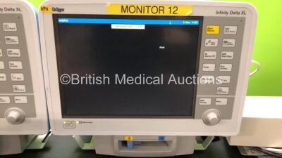 2 x Drager Infinity Delta XL Patient Monitors with HemoMed 1, Aux/Hemo 2, Aux/Hemo 3, NBP and MultiMed Options, 2 x Docking Stations and 2 x Power Supplies *Mfd 2006* (Both Power Up) - 2