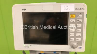 2 x Drager Infinity Delta Patient Monitors with HemoMed1 NIBP, Aux/Hemo3 and MultiMed Options, Docking Stations and Power Supplies on Stands (Both Power Up, 1 with Blank Screen and Damaged Casing - See Photo) *6000484275 / 4000478077* - 4