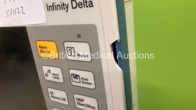 2 x Drager Infinity Delta Patient Monitors with HemoMed1 NIBP, Aux/Hemo3 and MultiMed Options, Docking Stations and Power Supplies on Stands (Both Power Up, 1 with Blank Screen and Damaged Casing - See Photo) *6000484275 / 4000478077* - 5