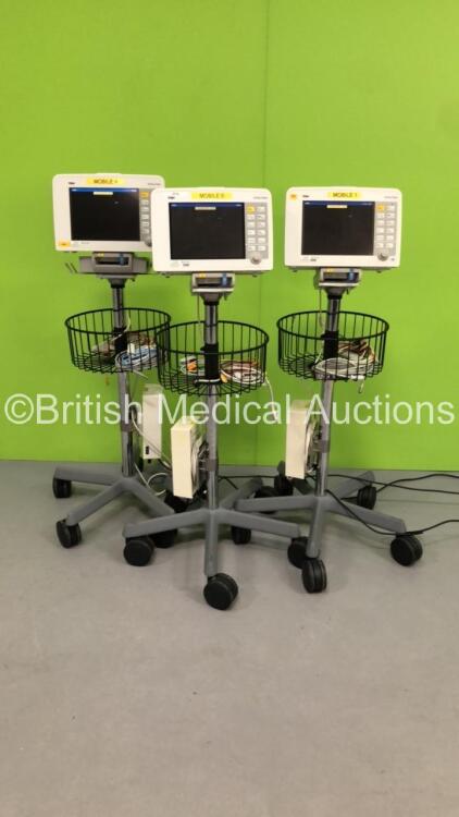 3 x Drager Infinity Delta Patient Monitors with HemoMed1, NIBP, Aux/Hemo3 and MultiMed Options, 3 x 3 Lead ECG Leads, 2 x SPO2 Finger Sensors, 2 x NIBP Hoses with 1 x Cuff, 3 x Docking Stations and 3 x Power Supplies on Stands (All Power Up, 1 with Damage