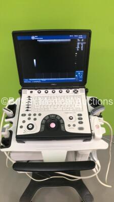 GE Logiq e Portable Flat Screen Ultrasound Scanner Software Version R9.0.2 with 3 x Transducers/Probes (1 x L4-12TRS * Mfd June 2015 *,1 x 3SCRS * Mfd August 2015 * and C1-5RS * Mfd July 2015 *) with Power Supply on GE Advanced Isolation Cart (Powers Up-S - 2