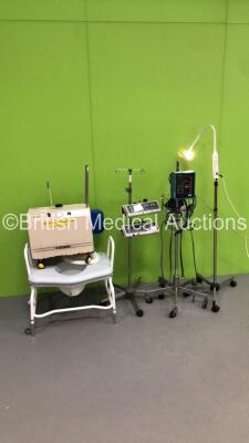 1 x Brandon Medical Lamp on Stand (Powers Up with Good Bulb), 1 x Dinamap Critikon 8100T Vital Signs Monitor on Stand (Powers Up), 2 x Graseby 3100 Syringe Pumps on Stand, 1 x Eschmann VP45 Suction Pump and 1 x Bariatric Commode