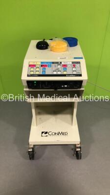 ConMed Aspen Surgical Aspen Excalibur Plus PC Electrosurgical Unit on Table with Footswitch (Powers Up)