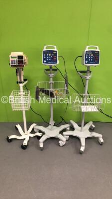 1 x CSI Criticare Vital Care 506DXNT Vital Signs Monitor on Stand and 2 x CSI Criticare ComfortCuff 506N3 Series Vital Signs Monitors on Stands (All Power Up - 1 x Damaged Handle - See Pictures *S/N 211522851 / 300362102 / 213725893*