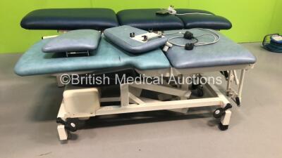 1 x Akron 3 Way Electric Patient Examination Couch with Controller and 1 x Huntleigh Electric Patient Examination Couch with Controller (Both Power Up - Both Marks to Cushions) - 2