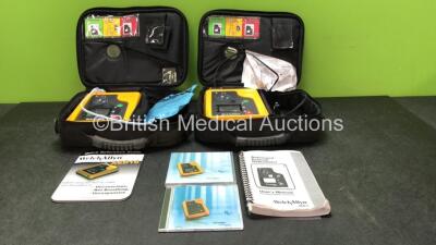 2 x Welch Allyn AED 10 Defibrillators with 2 x Electrode Pads, 1 x User's Manual and Service Guide DVD In Carry Bags (Both Untested Due to Possible Flat Batteries)