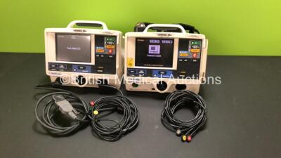 2 x Medtronic Physio-Control Lifepak 20e Defibrillator / Monitors with ECG and Printer Options, 2 x 3 Lead ECG Leads, 1 x Paddle Lead and 1 x External Hard Paddles (Both Power Up, 1 with Missing Door and Damaged Casing)