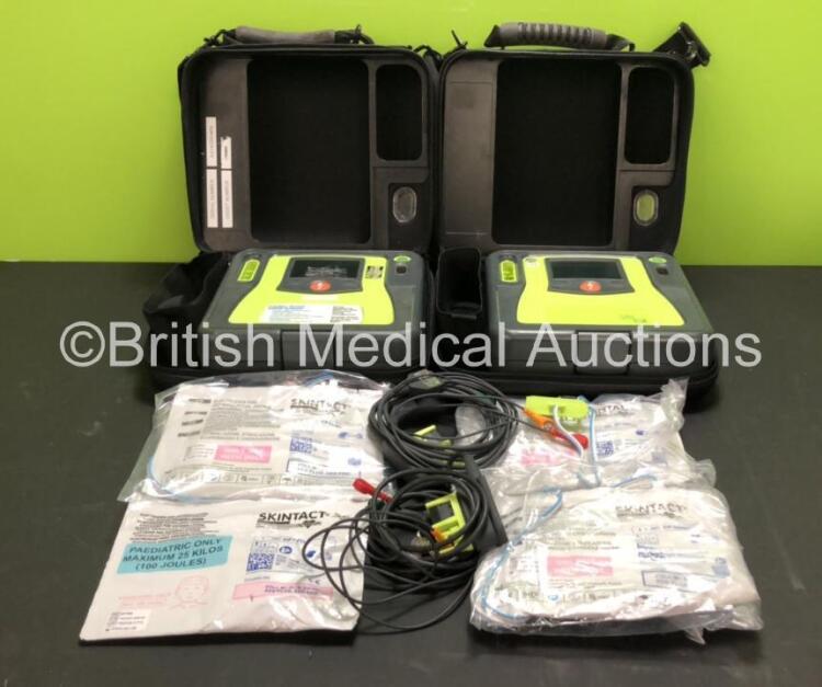 2 x Zoll AED Pro Defibrillators with 2 x ECG Leads, 2 x Batteries (2 x Flat Battery Included), 4 x Skintact Electrodes *Expiry Dates 02/2024, 02/2022, 10/2023 and 10/2023*, in Carry Cases (Both Power Up, 1 With Slight Damage to Screen, 2 x Flat Batteries