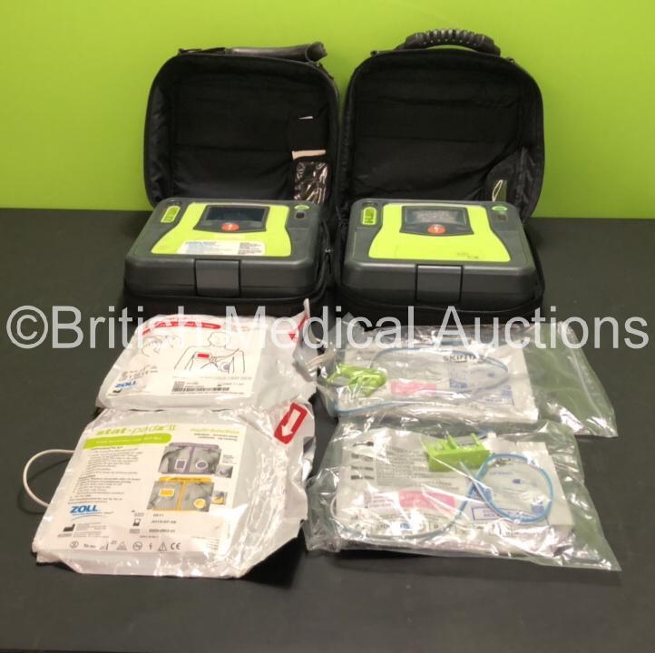 2 x Zoll AED Pro Defibrillators with 2 x Batteries (1 x Good Battery and 1 x Flat Battery) , 2 x Skintact Electrodes *Expiry Dates 10/2023 and 12/2023* and 2 x Stat-Padz Electrodes *2 x Expiry*, in Carry Cases (Both Power Up, 1 with Damaged Screen, 2 Batt