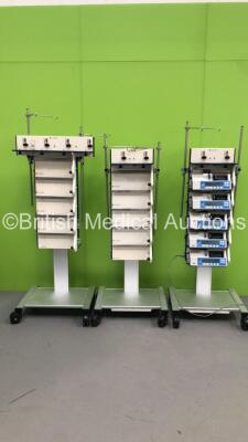 3 x Alaris Mobile Docking Stations with 5 x Alaris IVAC P6000 Syringe Pumps (All Power Up - Majority with Service Messages)