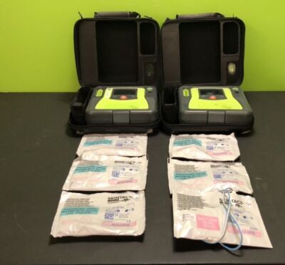 2 x Zoll AED Pro Defibrillators with 2 x Batteries (1 x Good Battery and 1 x Flat Battery) , 6 x Skintact Electrodes *All Expiry*, in Carry Cases (Both Power Up with 2 Batteries Included, 1 x Good Battery and 1 x Flat Battery)