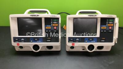 2 x Lifepak 20e Defibrillators (1 x Draws Power with Blank Screen and 1 x No Power - Both with Damaged Casing) *43873157 and 43873197*