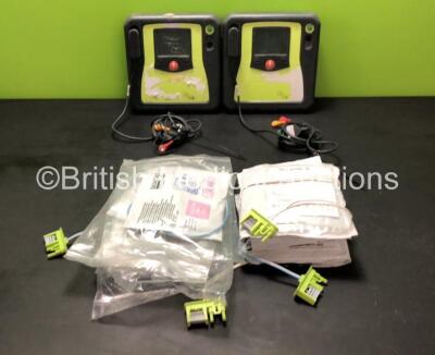 2 x Zoll AED Pro Defibrillators with 9 x Electrode Pads (Both Power Up with 1 x Unit Failed, 1 x Unit OK - Batteries Not Included - Slight Damage to Screens)