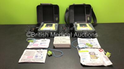 2 x Zoll AED Pro Defibrillators with 4 x Batteries, 2 x ECG Leads and 4 x Electrode Packs (2 x In Date) in 2 x Carry Cases (Both Power Up with Some Marks to Screen - See Photo)