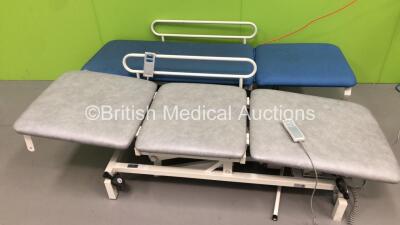 1 x Akron Electric Patient Examination Couch with Controller and 1 x Huntleigh Electric 3 Way Patient Examination Couch with Controller (Both Power Up - Rips to Cushions - See Photos)