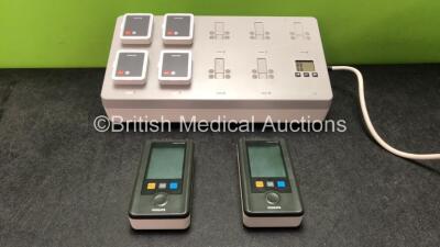 2 x Philips IntelliVue MX40 Patient Monitoring Systems Including ECG and SpO2 Options *Mfd 07/2012, 07/2014* with 1 x Philips Ref 865220 Battery Charger *Mfd 06/2014* 5 x Batteries (Powers Up, 1 Unit with Damaged Battery Cover-See Photo) - 5