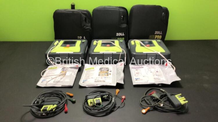 3 x Zoll AED Pro Defibrillators with 3 x Batteries, 3 x ECG Leads and 3 x Electrode Packs in Carry Cases (All Power Up, 1 x Slight Damage to Screen - See Photos) *AA07E005955, AA10C016679 and AA07D005578*