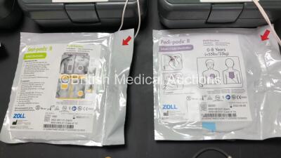 3 x Zoll AED Pro Defibrillators with 3 x Batteries, 3 x ECG Leads and 3 x Electrode Packs in Carry Cases (All Power Up, 1 x Slight Damage to Screen - See Photos) *AA07E005955, AA10C016679 and AA07D005578* - 6