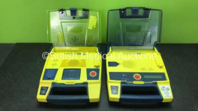 2 x Cardiac Science PowerHeart G3 Defibrillators (1 x Pro) with 1 x Battery (Both Power Up - Battery Low)