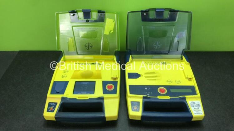 2 x Cardiac Science PowerHeart G3 Defibrillators (1 x Pro) with 1 x Battery (Both Power Up - Battery Low)