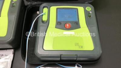 3 x Zoll AED Pro Defibrillators with 3 x Batteries, 2 x ECG Leads, 6 x Electrode Packs and 2 x Carry Cases (All Power Up, 3 x Damage to Screens and 2 x Slight Damage to Casing - See Photos) - 5