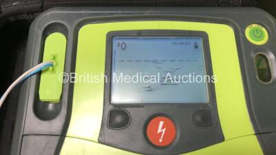 3 x Zoll AED Pro Defibrillators with 3 x Batteries, 2 x ECG Leads, 6 x Electrode Packs and 2 x Carry Cases (All Power Up, 3 x Damage to Screens and 2 x Slight Damage to Casing - See Photos) - 6