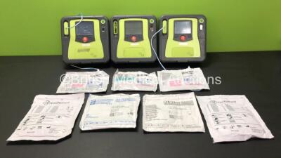 3 x Zoll AED Pro Defibrillators with 2 x Batteries and 3 x Electrode Packs (All Power Up, 3 x Damage to Screens - See Photos)