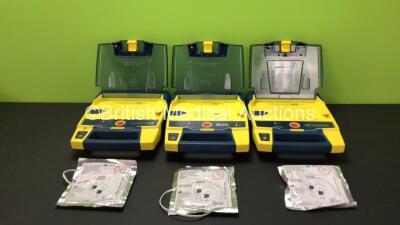 3 x Cardiac Science Powerheart AED G3 Automated External Defibrillators with 3 x Batteries and 3 x Defibrillation Electrodes (All Power Up, 2 x Low Batteries)