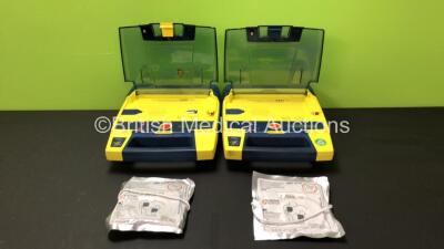 2 x Cardiac Science Powerheart AED G3 Automated External Defibrillators with 2 x Batteries and 2 x Defibrillation Electrodes (All Power Up, 2 x Low Batteries)