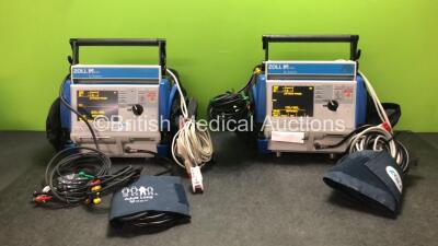 2 x Zoll M Series Biphasic 200 Joules Max Defibrillators Including ECG, SpO2 and Printer Options with 2 x Batteries, 2 x 3 Lead ECG Leads, 2 x Paddle Leads, 2 x NIBP Hoses, 2 x BP Cuffs and 2 x SpO2 Finger Sensors in Carry Bags (Both Power Up)