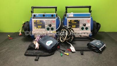 2 x Zoll M Series Biphasic 200 Joules Max Defibrillators Including Pacer, ECG, SpO2 and Printer Options with 2 x Batteries, 2 x 3 Lead ECG Leads, 2 x Paddle Leads, 2 x NIBP Hoses, 2 x BP Cuffs and 2 x SpO2 Finger Sensors in Carry Bags (Both Power Up)