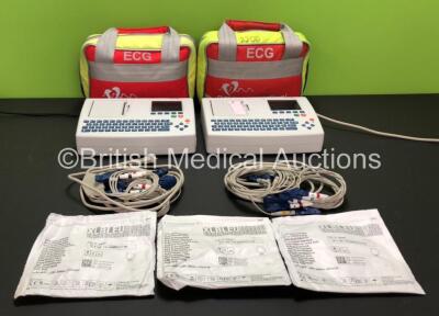 2 x Schiller AT-101 EKG Machines with Leads and 3 x ECG Electrodes Packs (All Expired 2022) in 2 x Carry Bags (1 x No Power, 1 x Missing Earthing Connection - See Photos)