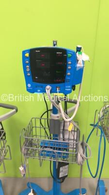 2 x GE ProCare Auscultatory Vital Signs Monitors on Stands with BP Hoses, 1 x GE Carescape V100 Vital Signs Monitor on Stand with SPO2 Finger Sensor and BP Hose and 1 x GE Dinamap Pro 400 Vital Signs Monitor on Stand with SPO2 Finger Sensor and BP Hose (A - 5