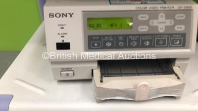 2 x Olympus Stack Trolleys Including 2 x Pentax LED High -Bright Monitors, Olympus OES PSD-20 Electrosurgical Unit, Sony UP-21MD Colour Video Printer, Olympus Evis Lucera CV-260SL Digital Processor, Olympus MAJ-1154 Pigtail Connector, Olympus Evis Lucera - 3