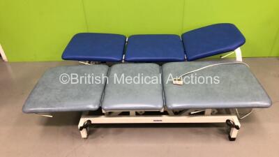 1 x Akron Electric 3 Way Patient Examination Couch with Controller (Powers Up) and 1 x Bristol Maid Electric 3 Way Patient Examination Couch with Controller (Unable to Power Test Due to No Controller) *Rips to Cushions*