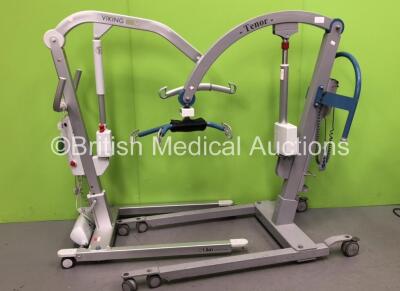 1 x Viking M Electric Patient Hoist with 1 x Battery and 1 x Controller (No Power with Missing Wheel-See Photo) 1 x Arjo Tenor Patient Hoist (Untested Due to missing Battery with Damaged Controller-See Photo)