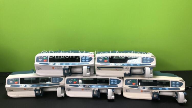 Job Lot Including 4 x CareFusion Alaris GH Syringe Pumps and 1 x Cardinal Health Alaris GH Syringe Pump (All Power Up, 1 x Does Not Charge, 2 x Damage to Casing - See Photos)