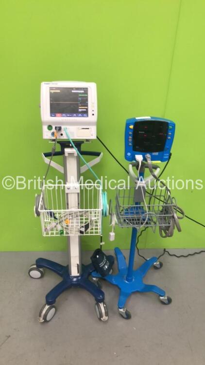1 x Fukuda Denshi DS-7100 Monitor on Stand with ECG, SpO2 and BP Leads and 1 x GE Carescape V100 Dinamap Monitor on Stand with SpO2 and BP Leads (Both Power Up)