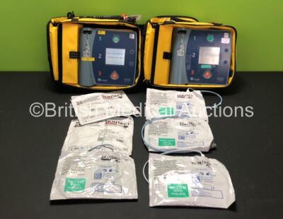 2 x Laerdal Heartstart FR2+ Defibrillators in Carry Bags with 1 x Philips M3863A Battery and 6 x Electrode Packs *All in Date* (Both Power Up and Pass Self Tests) **SN 0510801449 / 0307227367**