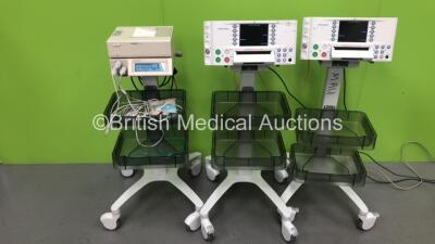 2 x Huntleigh SonicAid FM800 Encore Fetal Monitors on Stands (Both Power Up with 1 x Missing Power Button) and 1 x Huntleigh Sonicaid Team Duo Fetal Monitor on Stand with 3 x Transducers (Powers Up)