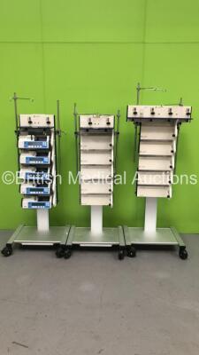 3 x Alaris Mobile Docking Stations with 5 x Alaris IVAC P6000 Syringe Pumps (All Power Up - Majority with Service Messages)