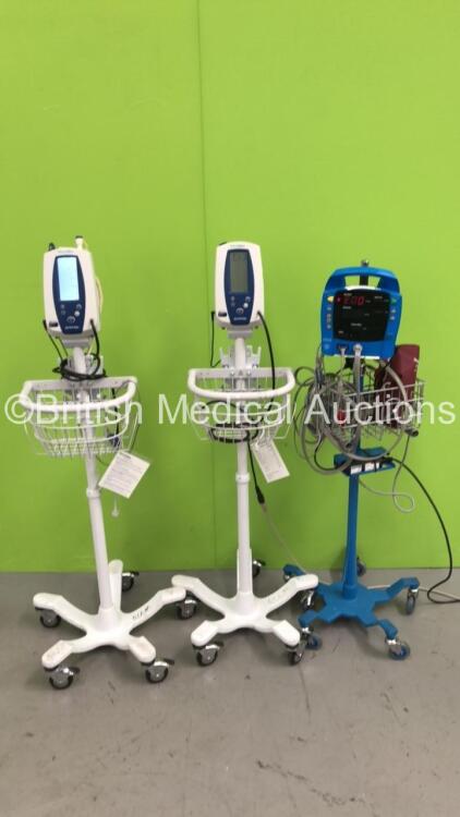 2 x Welch Allyn SPOT Vital Signs Monitors on Stands and 1 x GE Dinamap ProCare Auscultatory Vital Signs Monitor on Stand (All Power Up)