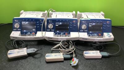 Job Lot Including 2 x Philips Heartstart XL Smart Biphasic Defibrillators with ECG and Printer Options (Both Power Up with 1 x Damaged Speaker Cover - See Photos) 1 x Philips Heartstart XL Smart Biphasic Defibrillator with Pacer, ECG and Printer Options (