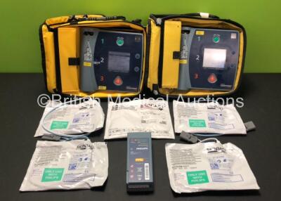 2 x Laerdal Heartstart FR2 Defibrillators in Carry Bags with 3 x Philips M3863A Batteries and 5 x Electrode Packs *3 x Expired* (Both Power Up and Pass Self Tests) **SN 1002073519 / 1002073515**